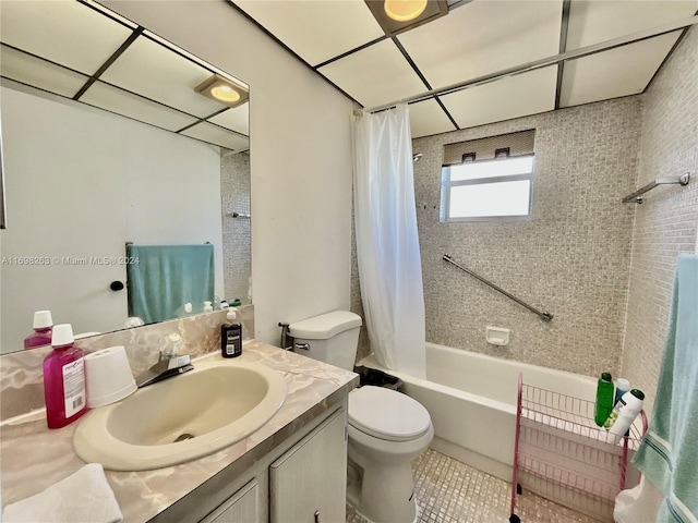 full bathroom featuring tile patterned flooring, vanity, toilet, and shower / bathtub combination with curtain