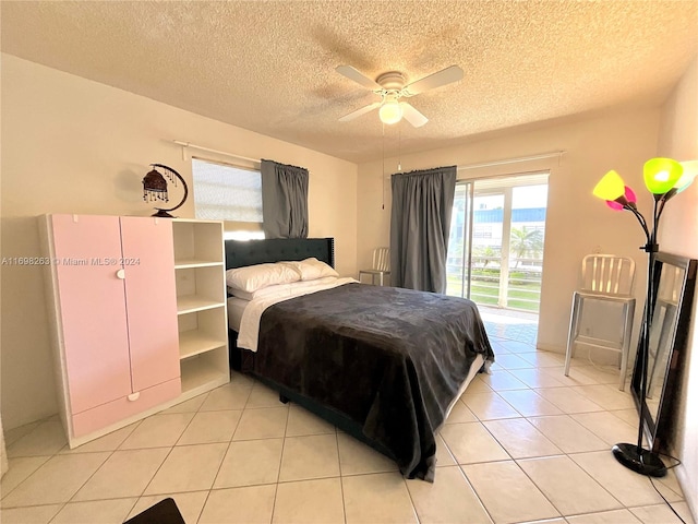 bedroom with ceiling fan, access to exterior, light tile patterned floors, and a textured ceiling