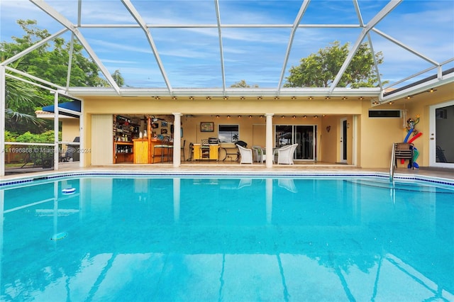 view of pool with ceiling fan, a lanai, and a patio