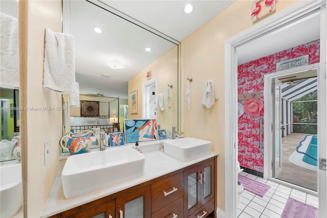 bathroom with tile patterned floors, vanity, a textured ceiling, and toilet