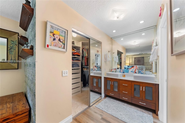 bathroom featuring vanity, a textured ceiling, and hardwood / wood-style flooring