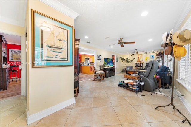 tiled living room with ceiling fan and crown molding