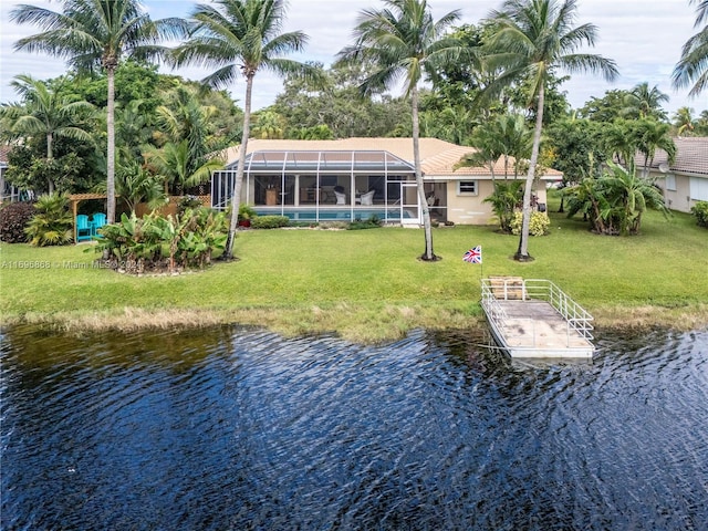 view of dock featuring a lanai, a water view, and a yard