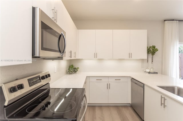 kitchen featuring white cabinetry and appliances with stainless steel finishes