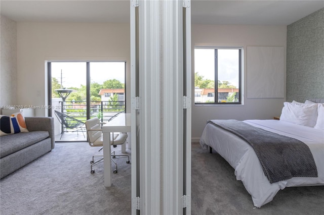 bedroom featuring carpet flooring, access to outside, and multiple windows