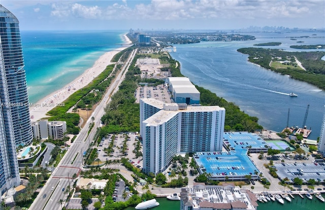 drone / aerial view with a beach view and a water view