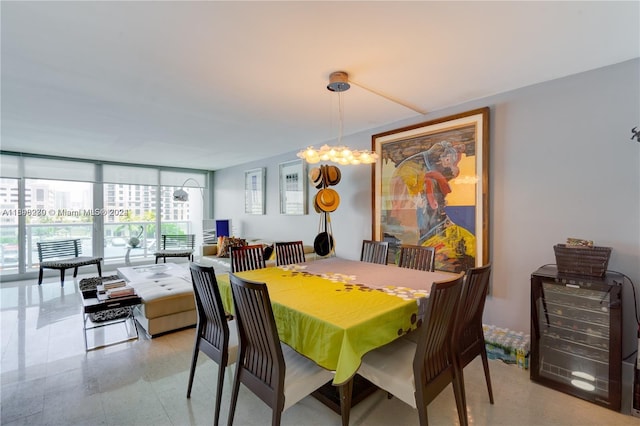 dining room with expansive windows and a notable chandelier