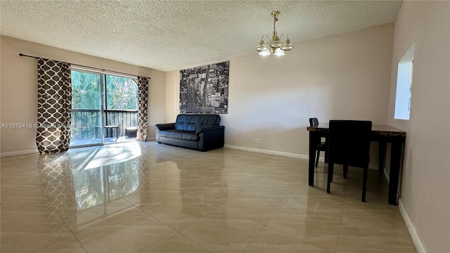 living room featuring light tile patterned flooring, a chandelier, and a textured ceiling