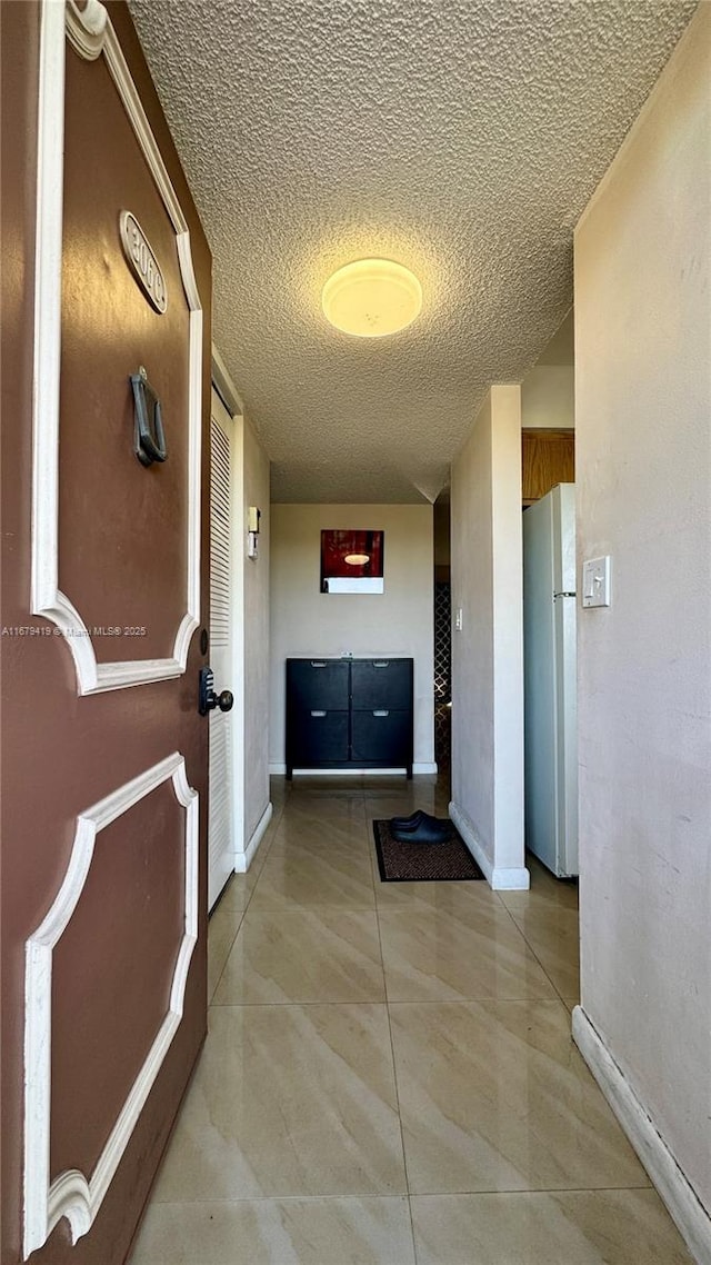 7060 Nova Dr Unit 306C, Davie, FL 33317 - corridor featuring baseboards and a textured ceiling
