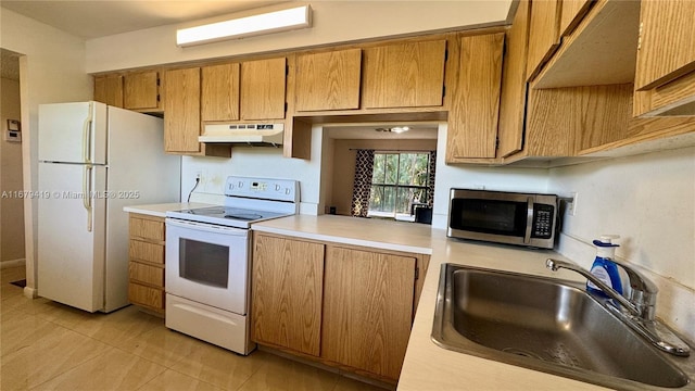 7060 Nova Dr Unit 306C, Davie, FL 33317 - kitchen featuring white appliances, light countertops, under cabinet range hood, light tile patterned floors, and brown cabinetry