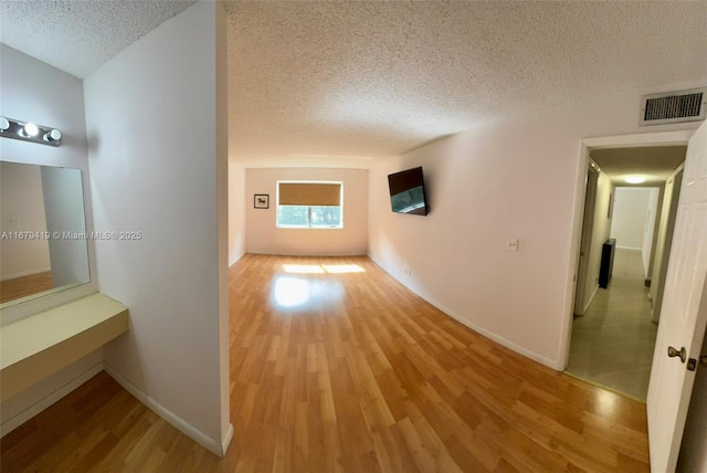 7060 Nova Dr Unit 306C, Davie, FL 33317 - hall featuring a textured ceiling and light wood finished floors
