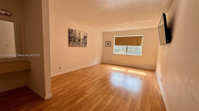 7060 Nova Dr Unit 306C, Davie, FL 33317 - spare room with a textured ceiling and wood finished floors
