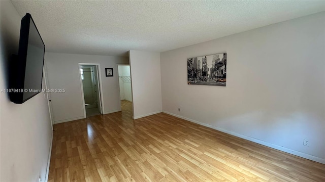 7060 Nova Dr Unit 306C, Davie, FL 33317 - spare room with light wood-style floors and a textured ceiling