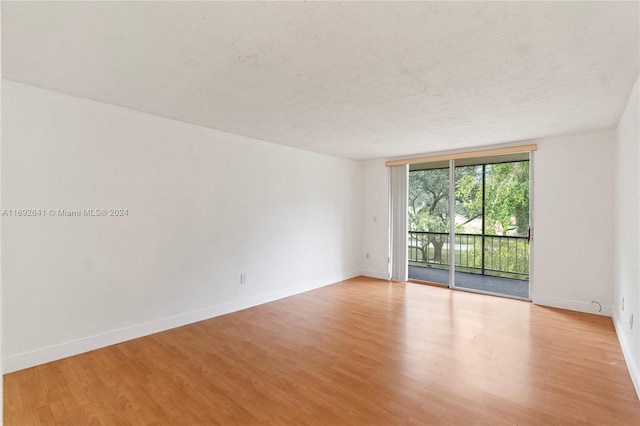 empty room featuring light hardwood / wood-style floors and a textured ceiling