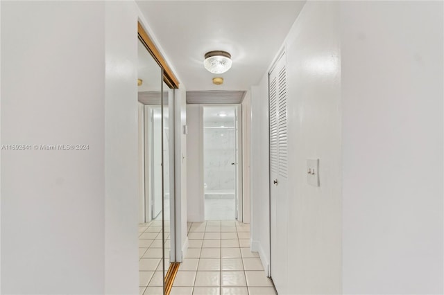 corridor featuring light tile patterned floors