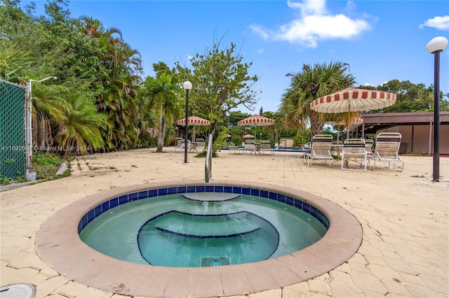 view of pool featuring an in ground hot tub and a patio