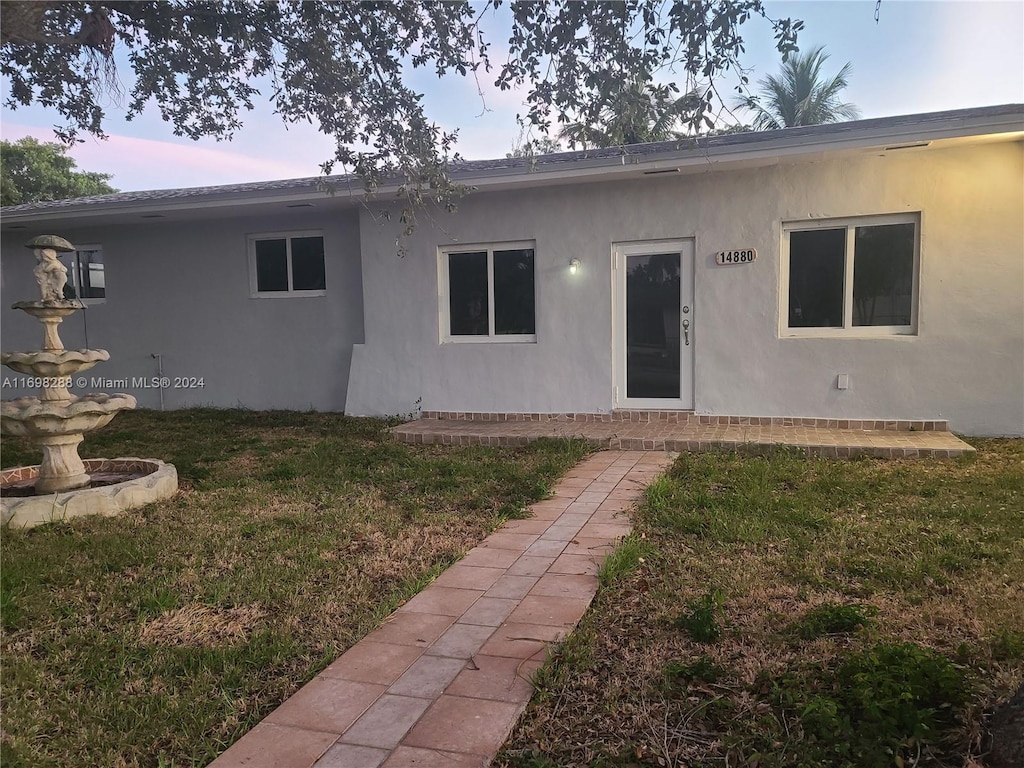 view of front of house with a yard