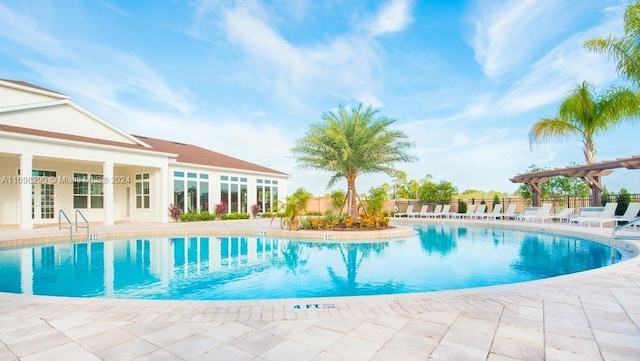 view of swimming pool featuring a patio and a pergola