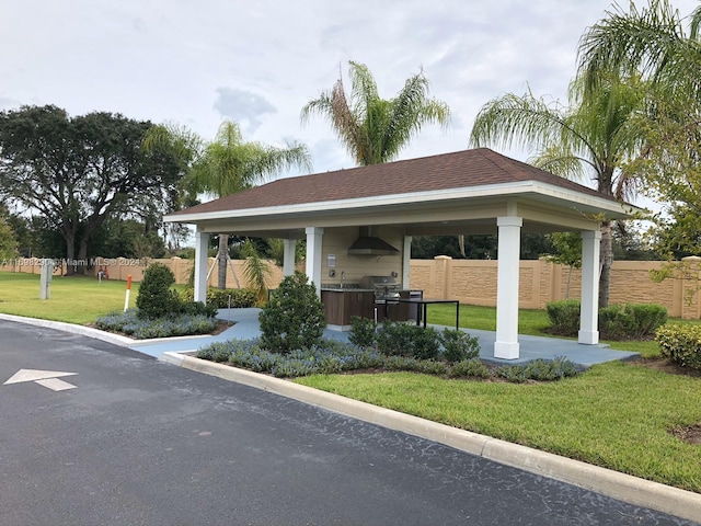 view of home's community with a gazebo, a lawn, and an outdoor kitchen