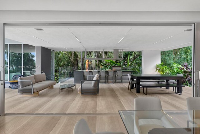 sunroom featuring a water view