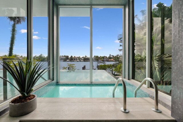 view of pool featuring a water view and a boat dock