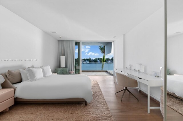 living area featuring floor to ceiling windows and light hardwood / wood-style flooring