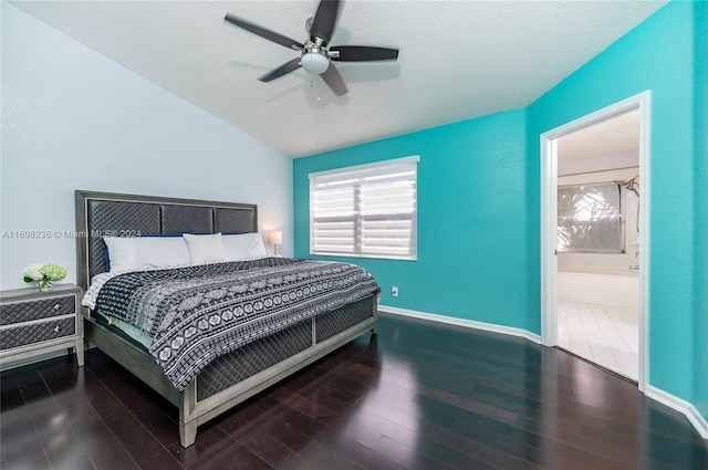 bedroom featuring lofted ceiling, ensuite bath, hardwood / wood-style flooring, ceiling fan, and a textured ceiling