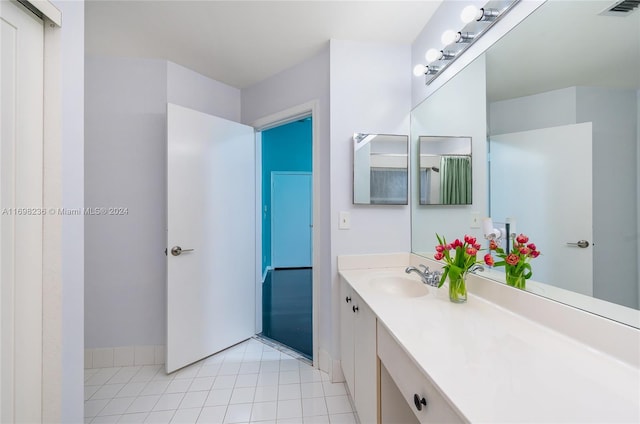 bathroom featuring tile patterned flooring and vanity