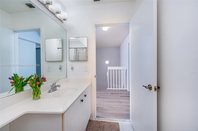 bathroom with hardwood / wood-style flooring and vanity