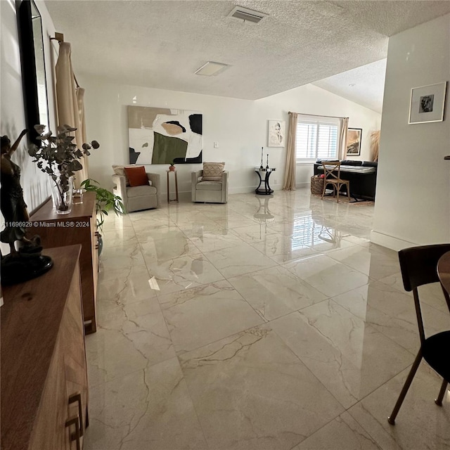 living room with a textured ceiling and lofted ceiling