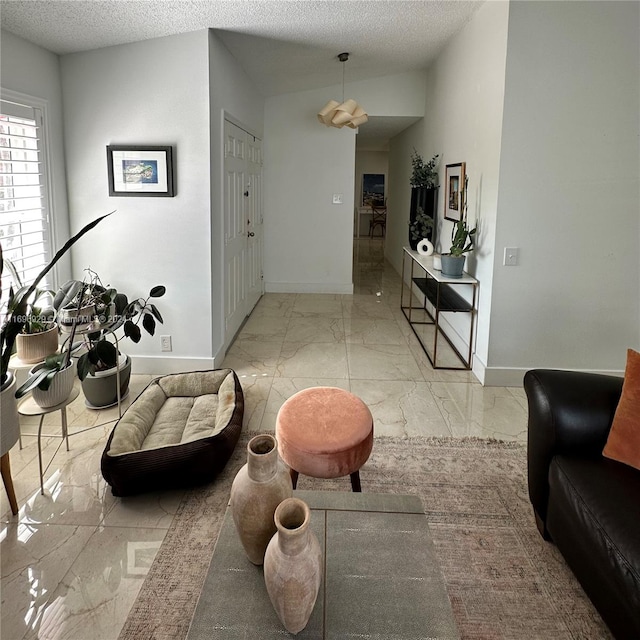 interior space featuring vaulted ceiling and a textured ceiling