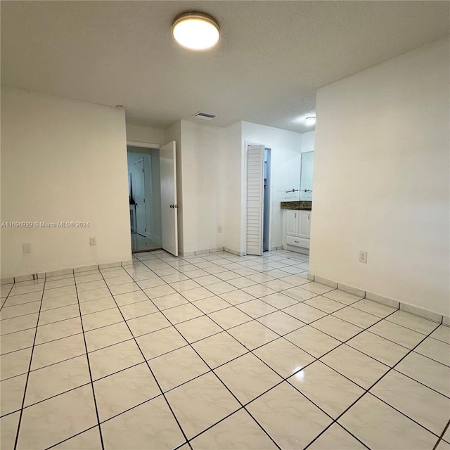 spare room with light tile patterned floors