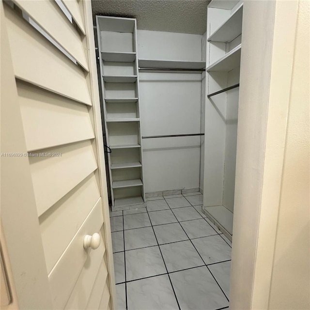 spacious closet with light tile patterned floors