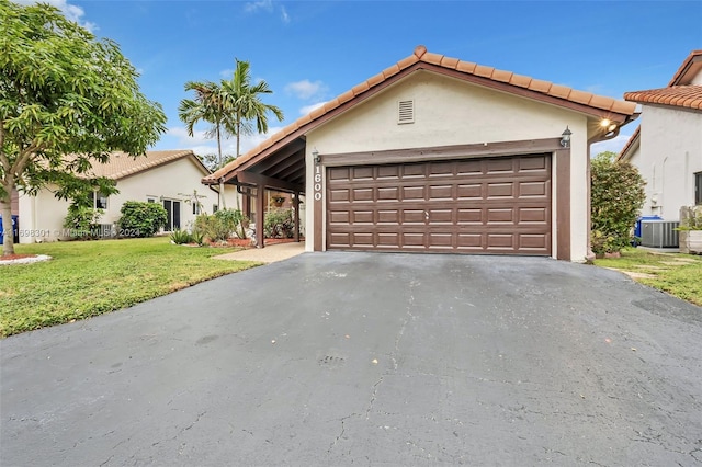 single story home with a front yard, central AC, and a garage