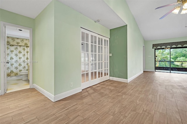 spare room featuring ceiling fan and vaulted ceiling