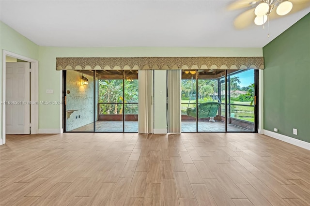 empty room featuring ceiling fan and light wood-type flooring