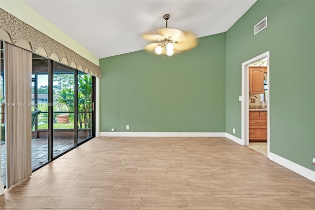 spare room with ceiling fan and lofted ceiling