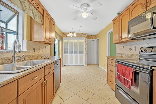 kitchen featuring backsplash, sink, light tile patterned floors, and stainless steel appliances