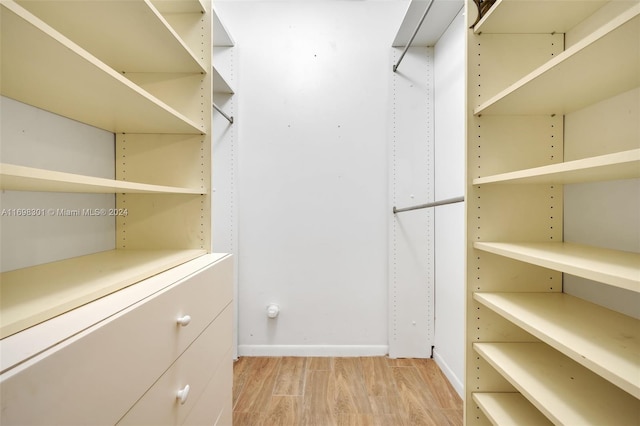 walk in closet featuring light hardwood / wood-style floors