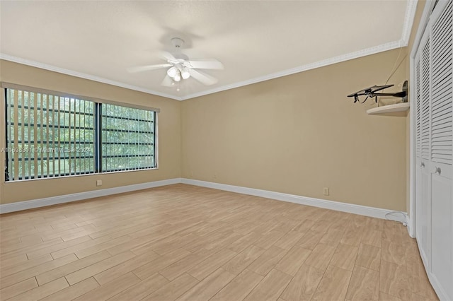 spare room featuring ceiling fan, crown molding, and light hardwood / wood-style flooring