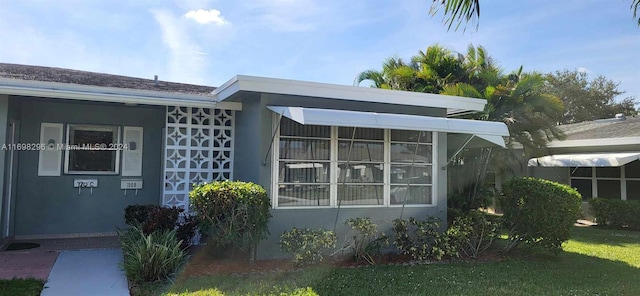 view of side of home featuring a yard