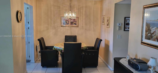 tiled dining space with a chandelier