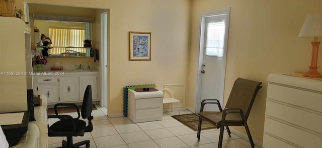 interior space with light tile patterned floors and sink