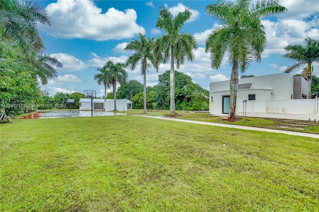 view of yard featuring a water view and basketball court