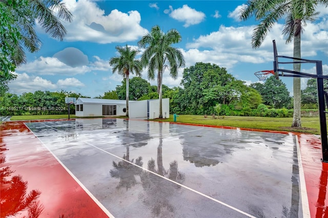 view of basketball court with a lawn