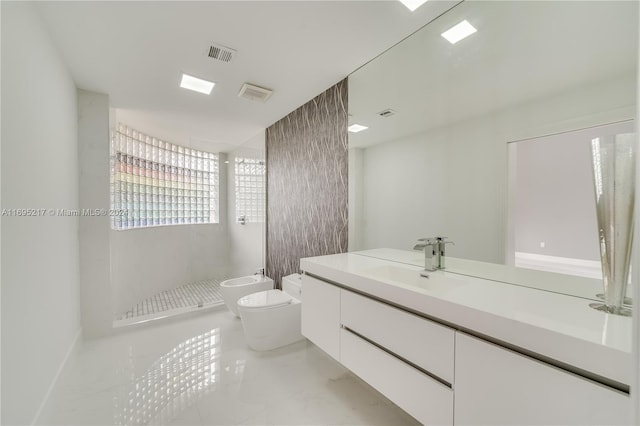 bathroom featuring walk in shower, vanity, toilet, and a bidet