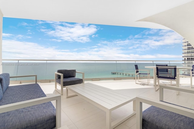 view of patio / terrace featuring a water view and a balcony