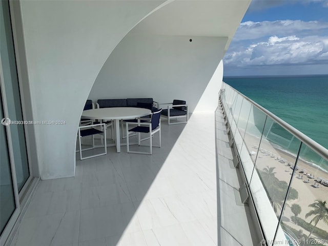 balcony with a view of the beach and a water view