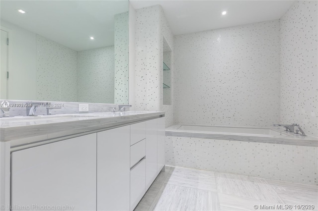 16901 Collins Ave Unit 1402, Sunny Isles Beach, FL 33160 - bathroom featuring double vanity, tiled tub, and recessed lighting