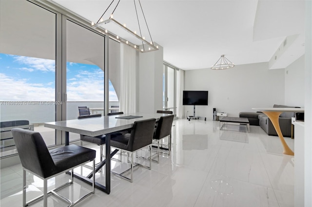 dining area featuring a notable chandelier and a water view